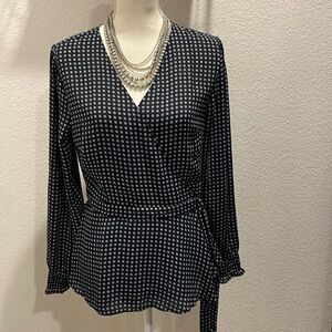 Ann Taylor Factory blue wrap blouse with long sleeve and peplum. Has a sm print.